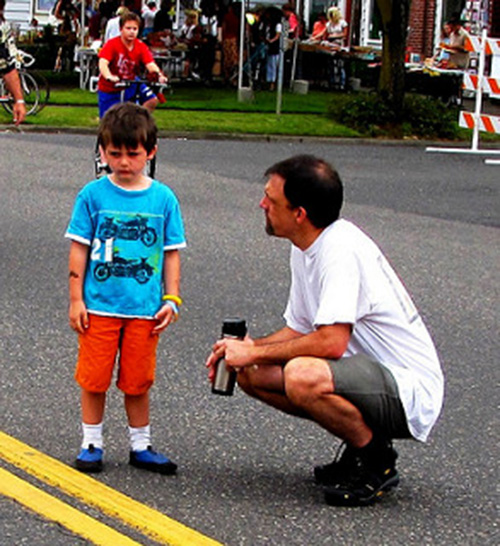 uomo-accucciato-accanto-a-bambino-triste