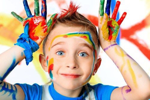 bambino-con-mani-e-viso-sporchi-di-colore