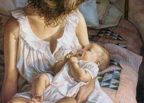 Un bambino ride felice tra le braccia della madre