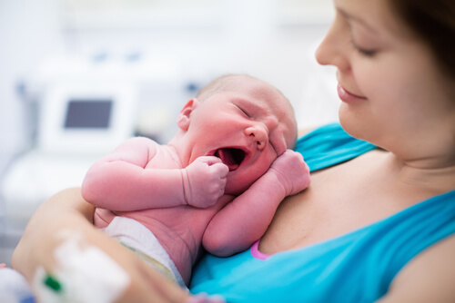 Neonato piange tra le braccia della madre