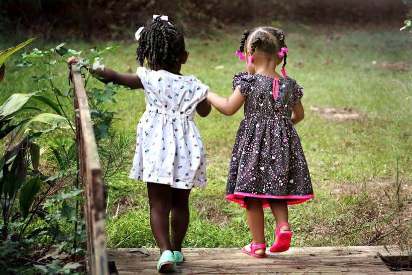 Due bambine passeggiano tenendosi per mano