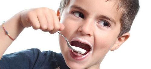 Bambino che mangia uno yoghurt