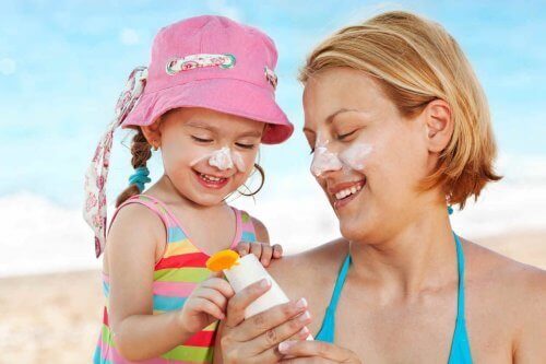 Mamma e figlia mettono la crema solare