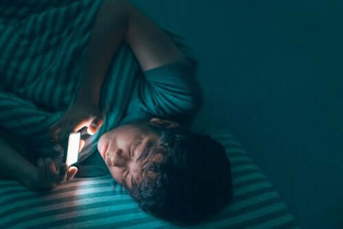 Adolescente che usa il cellulare di notte