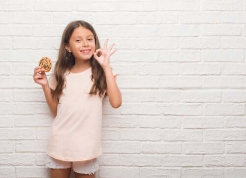 bambina che sorride con biscotto in mano