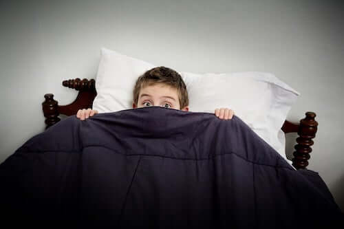 bambino a letto che non riesce a dormire
