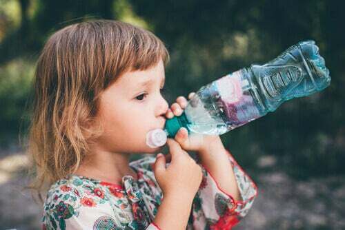 Bambina che beve acqua.