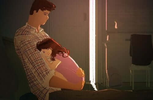 Padre che tiene la figlia in braccio.